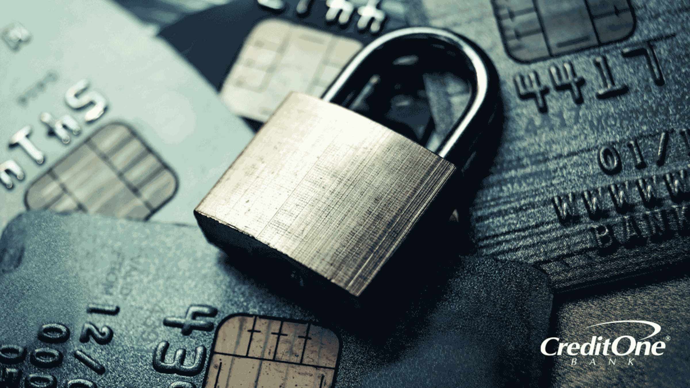 A lock sits on a pile of credit cards to represent secured credit cards.